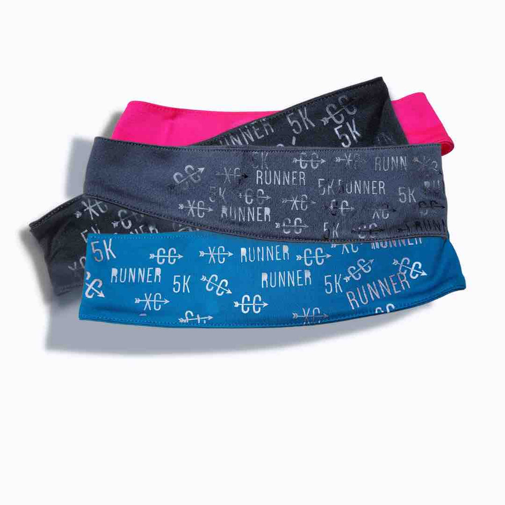 Headband with the words ‘5k’, ‘Runner’, ‘CC’, and ‘XC’ written on it in white. The headband is made of a soft, and stretchy material suitable for long distance and cross-country races. Available in Black, White, Pink and Charcoal Grey.