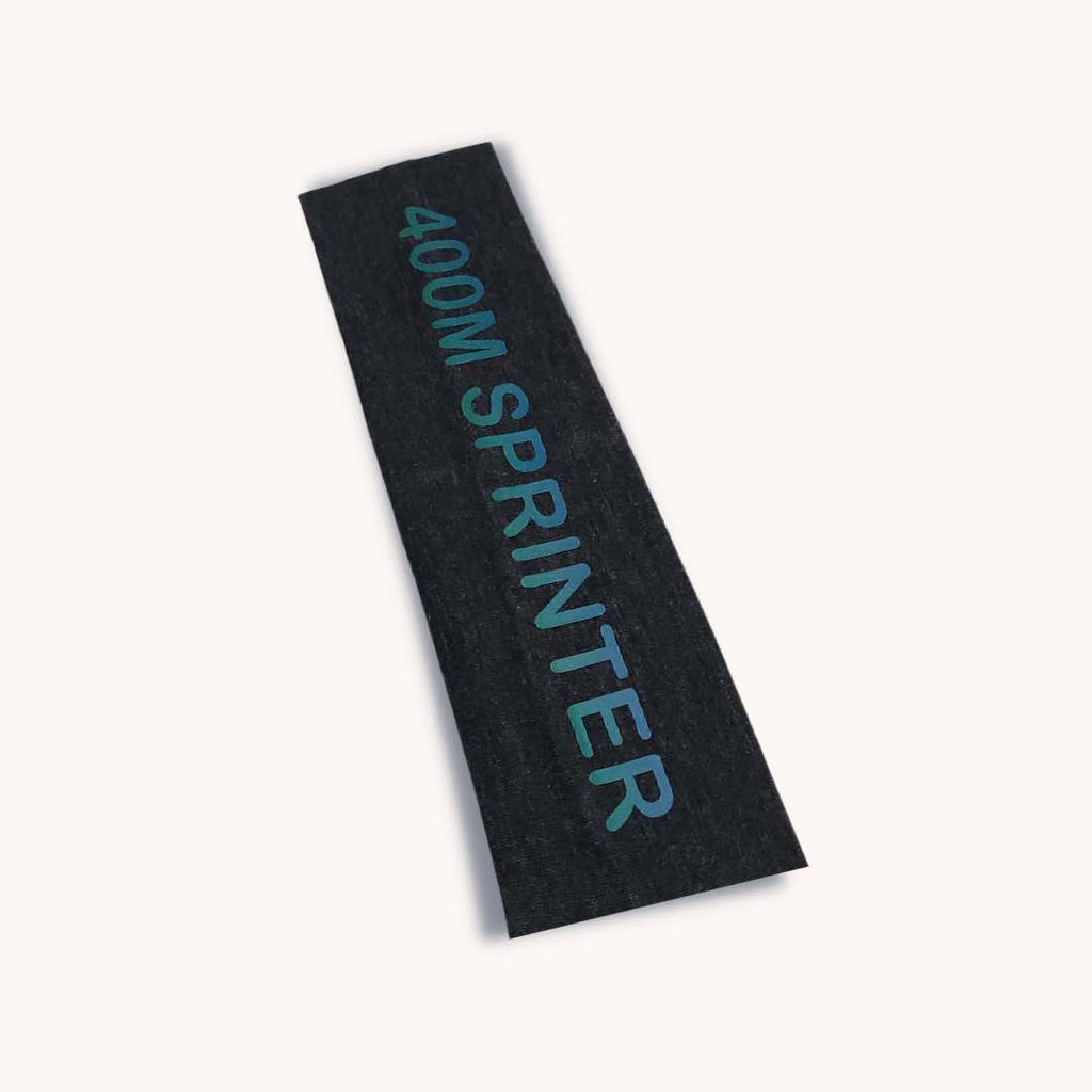 A grey moisture-wicking headband with blue "400M SPRINTER" print. Made from 100% cotton for unbeatable comfort and silicone for a firm grip. One size fit all.