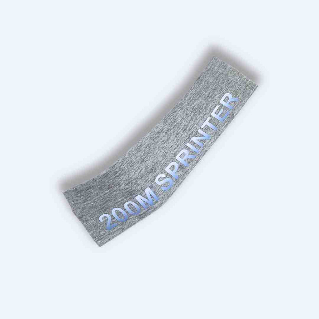 A light grey '200M Sprinter Headband' adorned with striking white and dark blue '200M SPRINTER' print. Made from 100% cotton with silicone for a firm grip. Tailored for track and field athletes.
