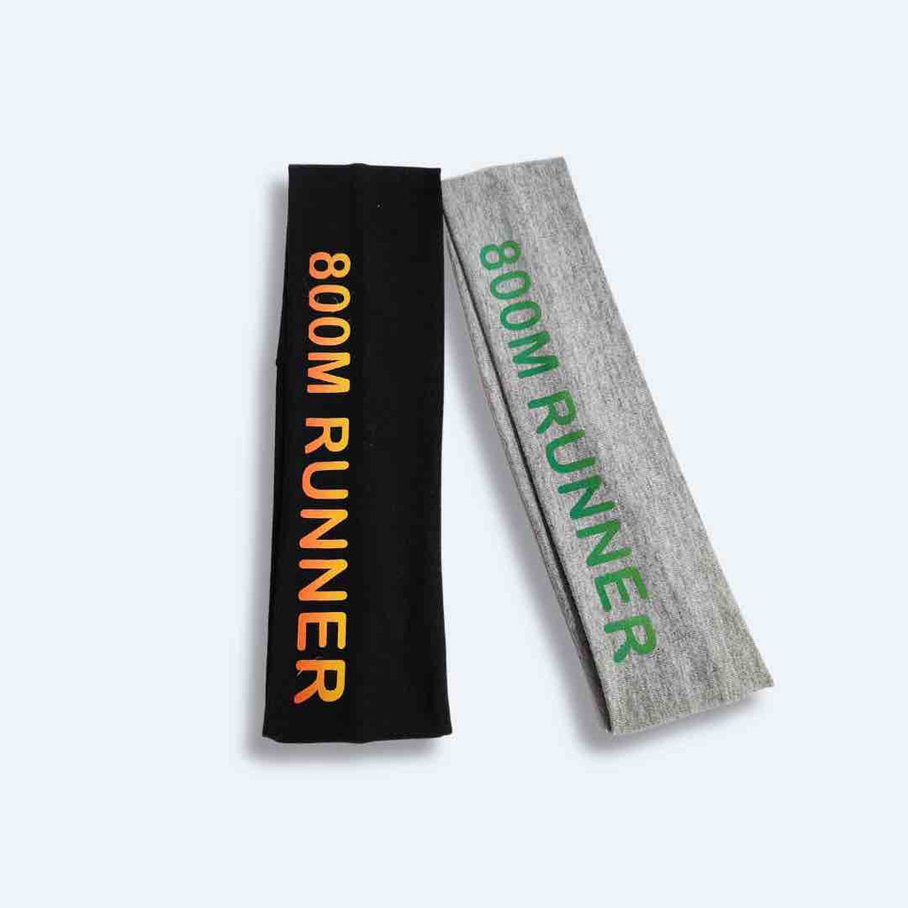 The ‘800 Metres Training Headband’ has the words "800M Runner" printed on it. This headband is made of 100% cotton fabric with silicone for a firm hold, making it perfect for intense workouts. It comes in Black and Light Grey