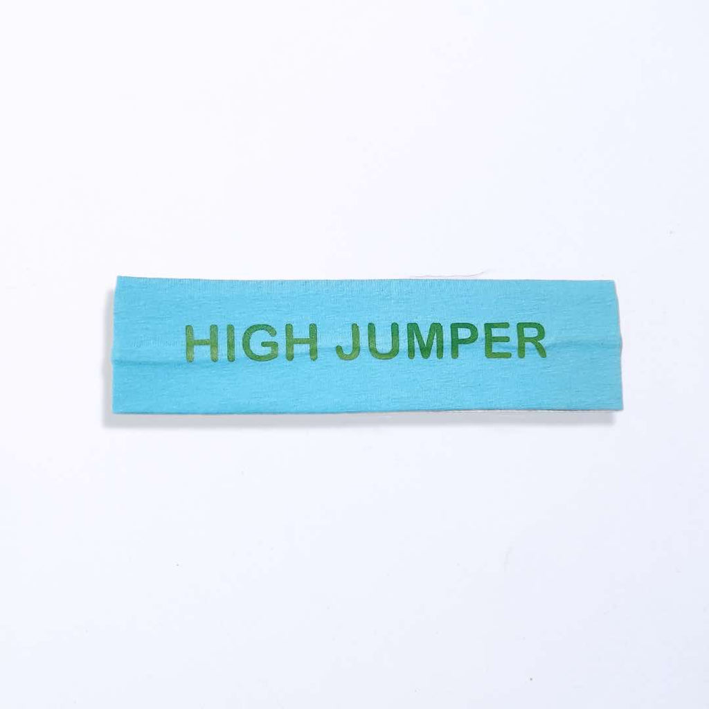 Light blue headband with the words "HIGH JUMPER" boldly printed on it in green. Made from 100% cotton fabric for unbeatable comfort and a silicone grip for a firm hold. Suitable for all head sizes.