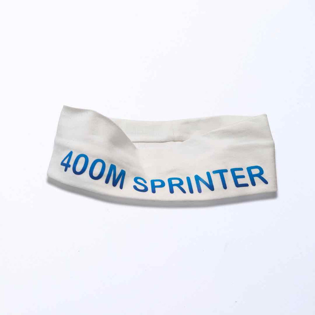 White headband with light blue "400M SPRINTER" print. 100% cotton that wicks moisture and silicone for a firm grip. One size fit all.