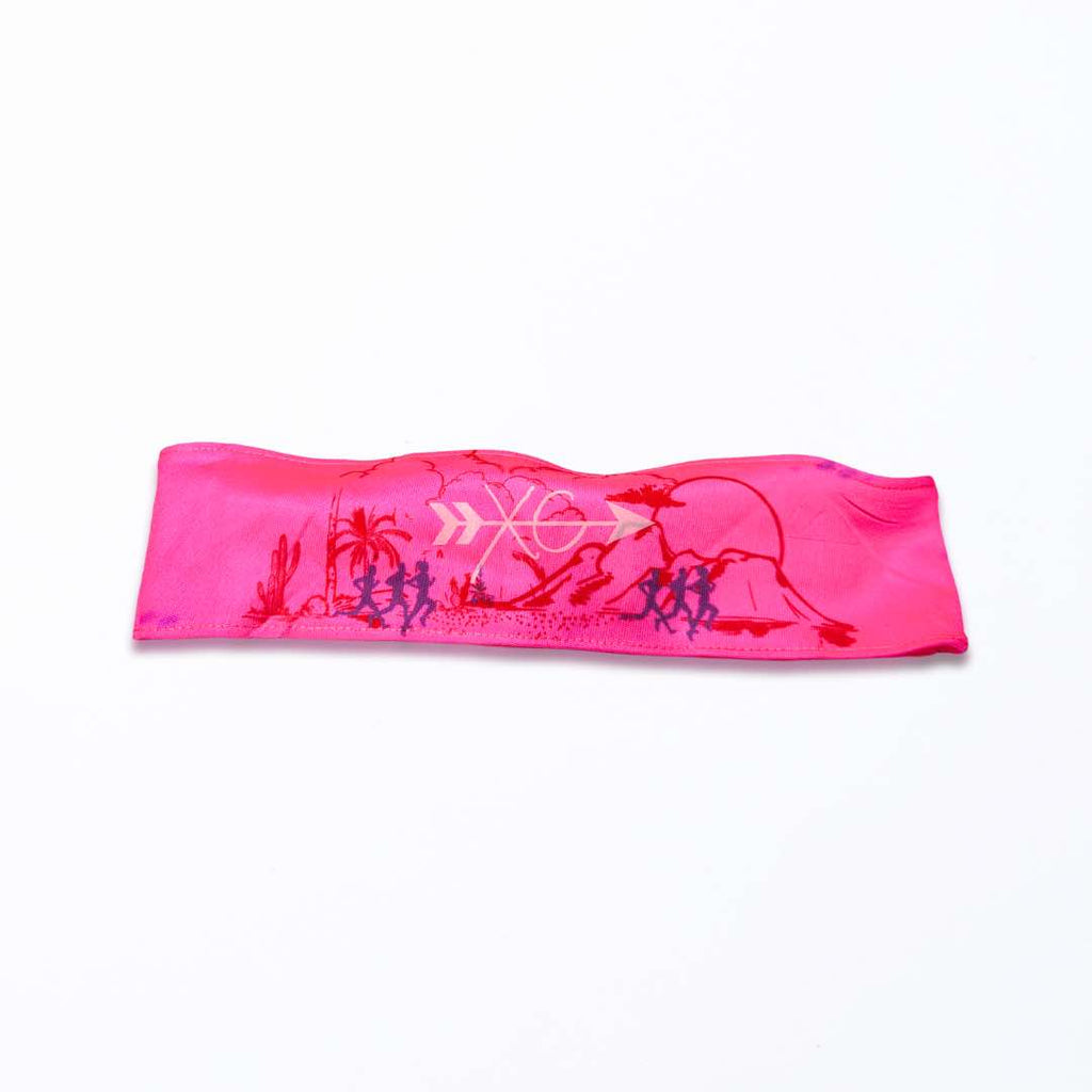 A close-up image of the Runner on a Trail Headband made from polyester fabric with a silicone grip for a secure fit. It’s a one size fit all headband and it’s available in two shades of pink.
