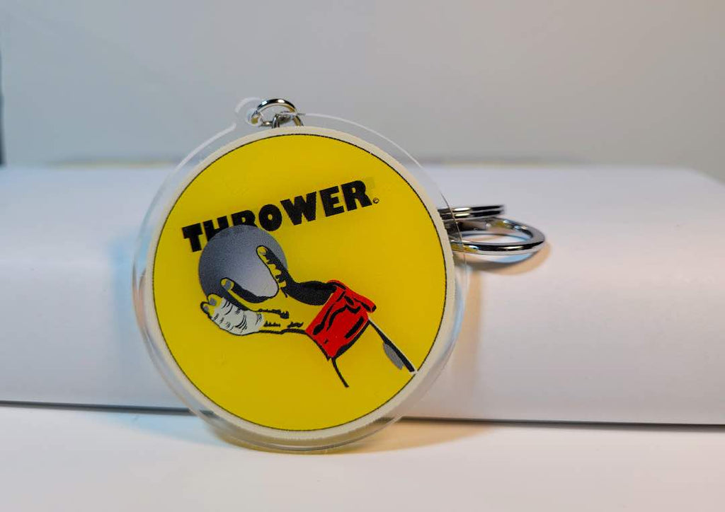 A clear acrylic keychain featuring a detailed design of a shot put thrower hand in action, a unique and stylish way to show love for track and field athletes."