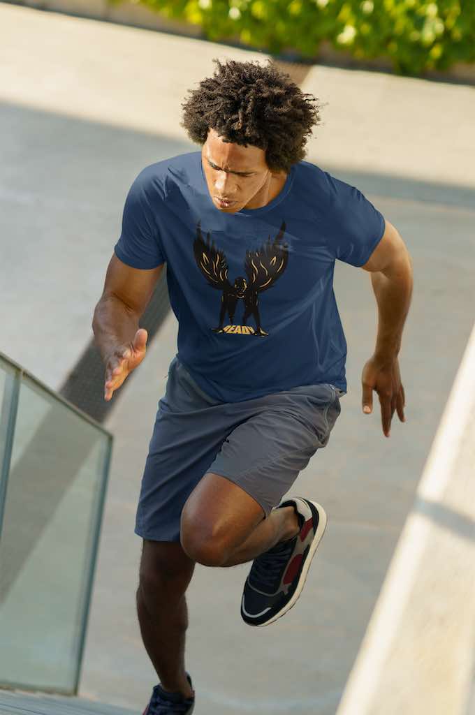 man running up stadium stairs wearing a navy T-shirt with a design of a 100m man in sprint position wearing wings
