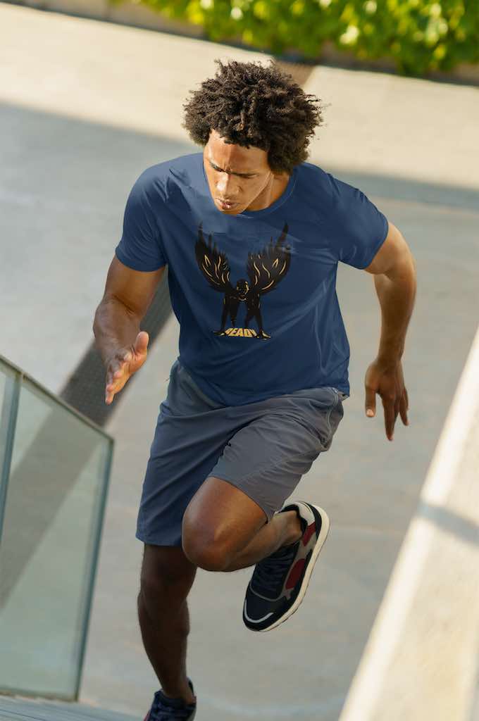 man running up stadium stairs wearing a navy T-shirt with a design of a 100m man in sprint position wearing wings